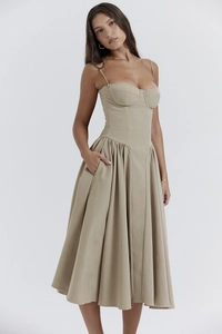 Detail of vintage French beige midi dress showing side pockets and structured corset top