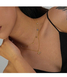 Close-up of double-layer gold necklace with colorful zircon stones and letter pendant
