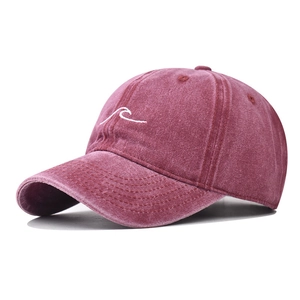 Close-up of vintage washed cotton baseball cap with white wave embroidery detail