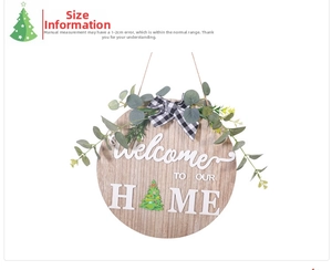 Detail of wooden welcome door sign with buffalo plaid bow and eucalyptus greenery