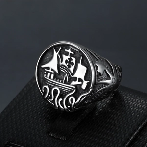 Macro detail of vintage sailing ship engraving on a stainless steel signet ring for men