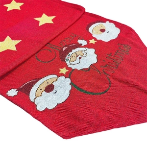 Red Christmas table runner featuring festive Santa Claus pattern and Merry Christmas text