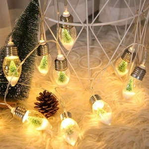 Warm LED Christmas string lights with miniature trees and snow inside clear bulbs