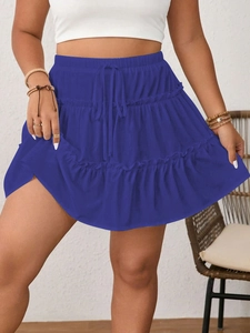 Detail of blue tiered cake skirt showing elastic drawstring waist and layered ruffle design
