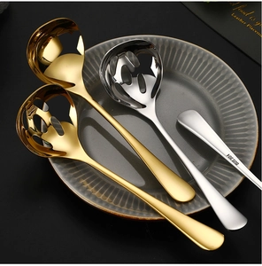 Close-up of golden and silver SUS 304 stainless steel soup spoons and slotted spoons