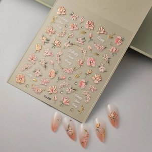 Macro detail of 5D embossed peony nail art stickers with gold trim and crystal accents