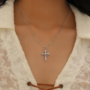 Fashion silver cross pendant necklace with sparkling rhinestones worn by a model