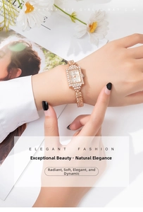 Detail of elegant rose gold square watch with crystal-encrusted bezel on woman wrist