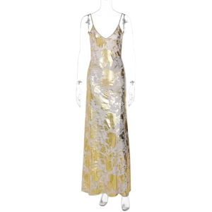 Close-up of gold metallic patterns on the white fabric of a V-neck backless summer dress