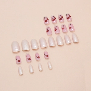 Press-on nail set featuring pearlescent white and pink cherry pattern designs