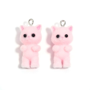 Close-up of pink flocked resin cat charms with metal hanging rings for DIY crafts