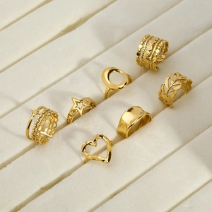 Set of 7 gold titanium steel rings featuring heart, star, and geometric open designs