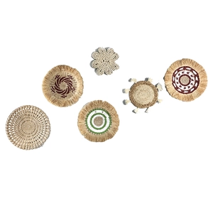 Set of 6 woven grass wall decor plates with boho geometric patterns and natural fiber texture