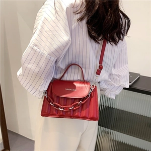 Chic red leather crossbody bag with chain strap and adjustable shoulder belt for women