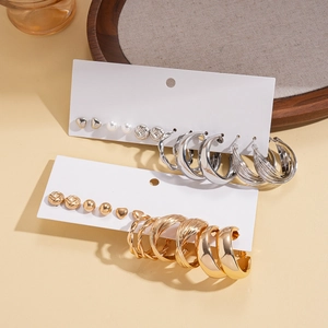 Detail view of 12-piece mixed geometric heart and twisted metal earrings in gold and silver