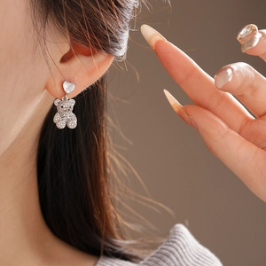 Gros plan de boucles d'oreilles ours en forme de cœur avec zircons étincelants