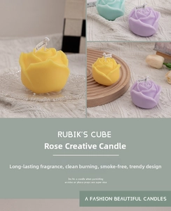 Close-up of rose shaped scented candles in pastel yellow, purple and mint green colors
