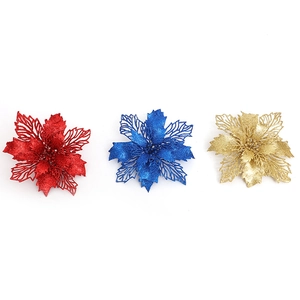 Glittering artificial poinsettia flowers in red, blue, and gold for Christmas tree decor