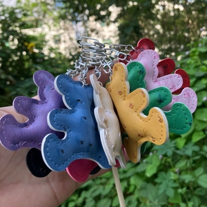 Macro view of colorful bear-shaped PU leather keychains with metal rings in various colors