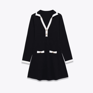 Classic black mini dress with long sleeves, white trim details and gold decorative buttons
