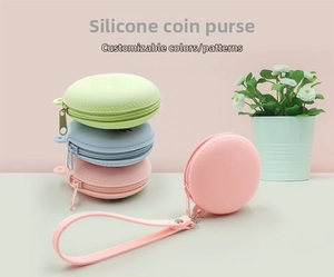 Detail view of round macaron silicone coin purses with smooth zippers and wrist straps