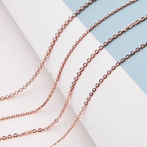 Detailed close-up of rose gold silver cable chains with fine interlocking ring structure