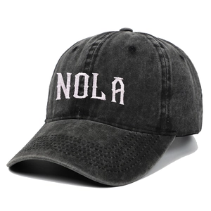Vintage washed black cotton baseball cap featuring white NOLA embroidery on the front