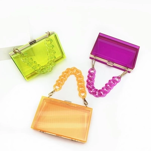 Clear acrylic evening bags in neon green, purple and orange with chunky chain straps
