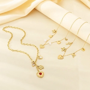 Golden stainless steel necklace set with heart clover and bow pendants on satin