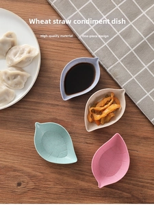 Leaf-shaped wheat straw condiment bowls in four pastel colors on a rustic wooden table