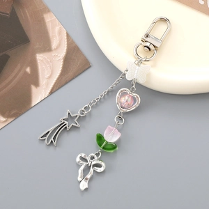 Detail of silver chain charm with transparent butterfly and pink heart beads