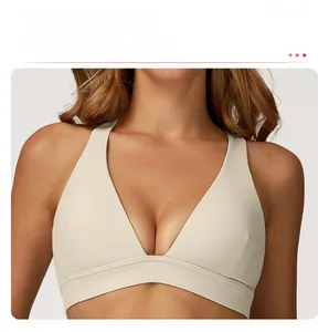 Detail of the low-cut V-neckline on the beige yoga sports bra showing neck curves