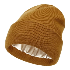 Detailed view of caramel knit beanie showing soft satin lining for hair protection
