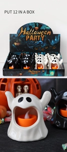 Close-up of Halloween ghost LED candle lamps in black and white with spooky pumpkin decor