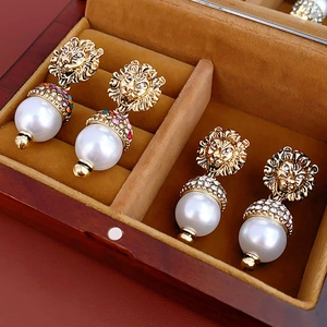 French vintage gold lion head pearl earrings with crystal details in a luxury gift box