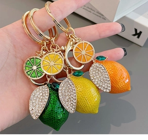 Detailed close-up of handmade lemon keychain with sparkling rhinestones and alloy ring