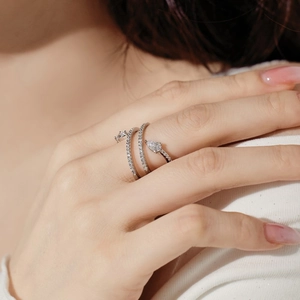 Detail of S925 silver triple-layered wrap ring with pear-shaped zircon on a finger