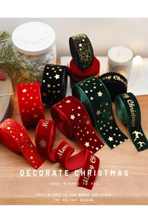 Detail of Christmas velvet ribbons with gold stamped reindeer and star patterns