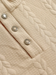 Detail of khaki quilted fabric with vintage metal buttons and diamond pattern texture
