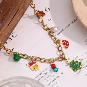 Detailed macro view of 18K gold plated Christmas charms with colorful enamel on chain