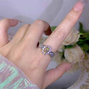 Detail view of oval opal ring with cubic zirconia accents on a delicate silver band
