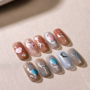 Glitter cat-eye blue and pink press-on nails with 3D silver bows and butterfly charms
