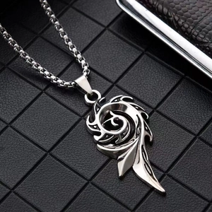 Macro shot of a tribal flame pendant on a box chain made of polished silver stainless steel