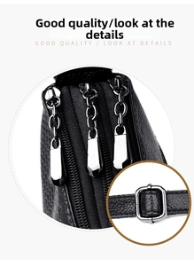 Detail of black PU leather bag showing three parallel zippers and silver hardware
