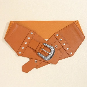 Close-up of brown elastic waist belt featuring a vintage carved silver buckle and rivets