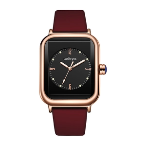 Macro shot of square quartz watch with burgundy strap and rose gold case detail