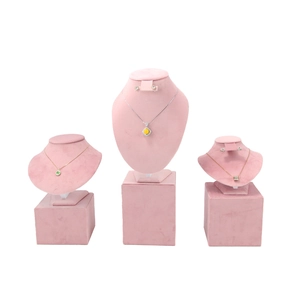 Detailed view of pink velvet necklace display busts on matching cubic stands for jewelry