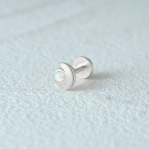 Macro shot of silver crescent moon stud earring with opal inlay and threaded flat back