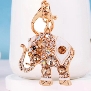 Macro detail of elephant keychain with sparkling crystals and white enamel finish