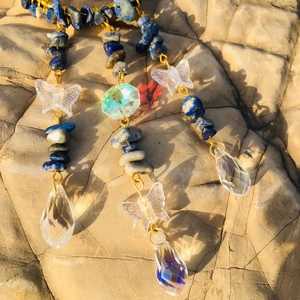 Detailed suncatcher view with lapis lazuli, crystal drops and butterfly charms on rock
